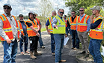 Image of public road workers in orange safety vests